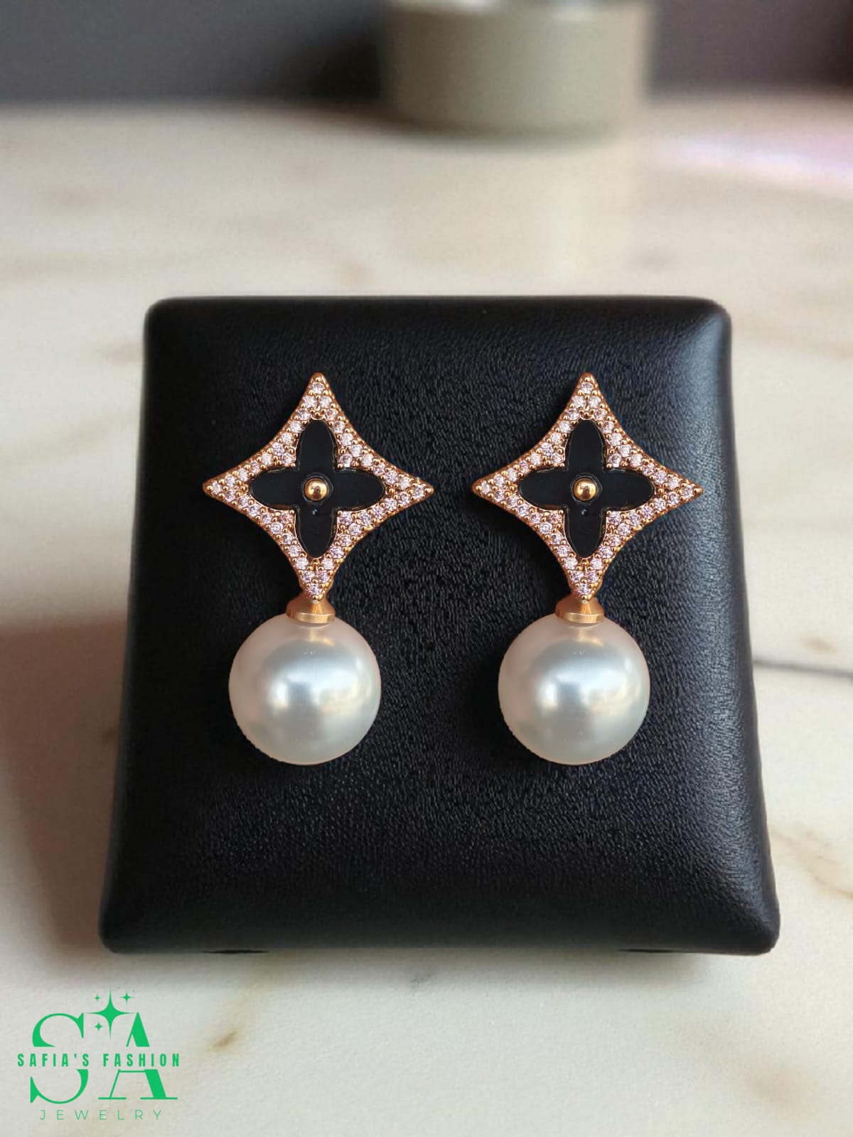 Black clover earrings with pearl drop design