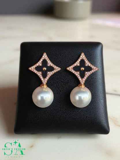 Black clover earrings with pearl drop design