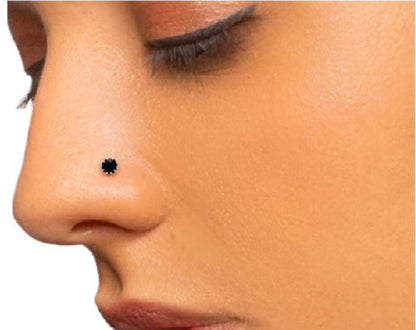 Close-up of a person wearing a black nose ring on a white background